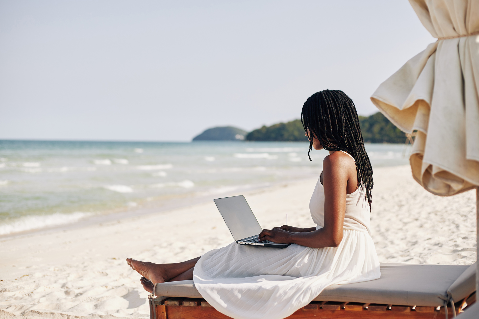 Woman Resting on Beach with Laptop